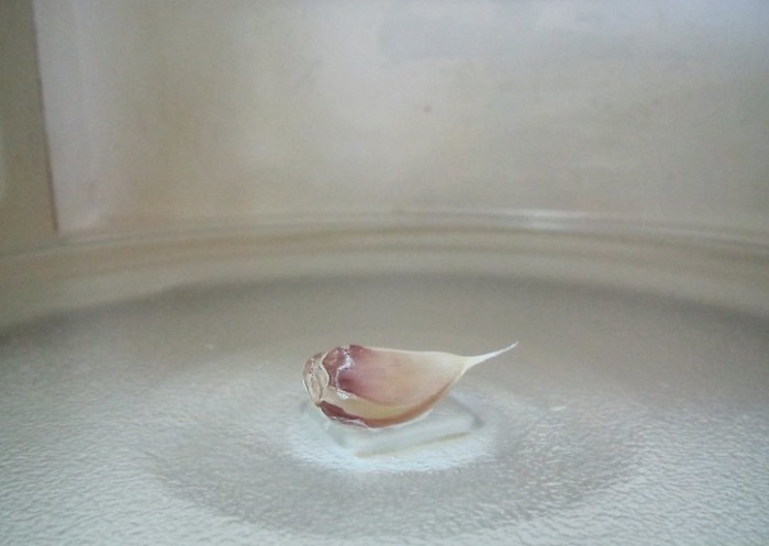 Чтобы шелуха отстала от чеснока, его нужно положить в микроволновку на несколько секунд. / Фото: wikihow.com