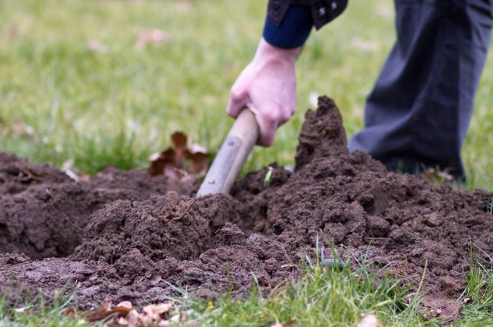 При выкапывании ям под забор есть риск задеть электрические кабели или трубы водопровода