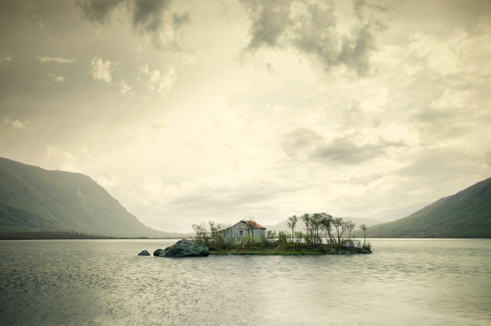 Одинокий дом на крошечном островке посреди озера.