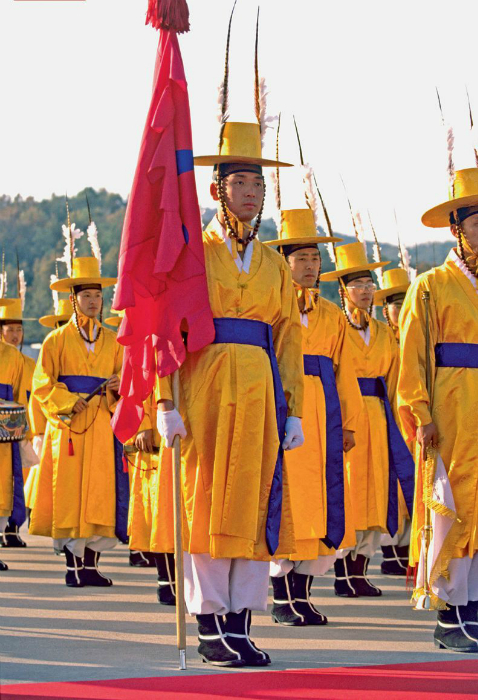 Солдаты элитного подразделения в желтых кимоно и больших шляпах-цилиндрах.