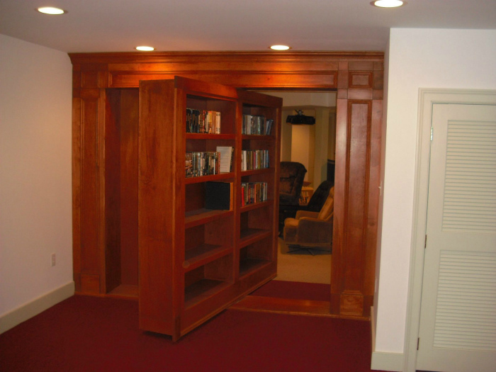 Поворотный книжный шкаф вместо двери.
