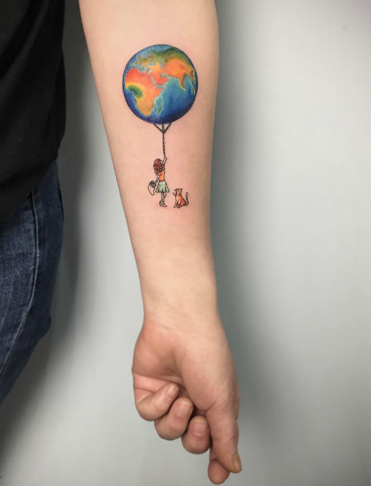 Татуировка с изображением девочки, кота и земного шара.