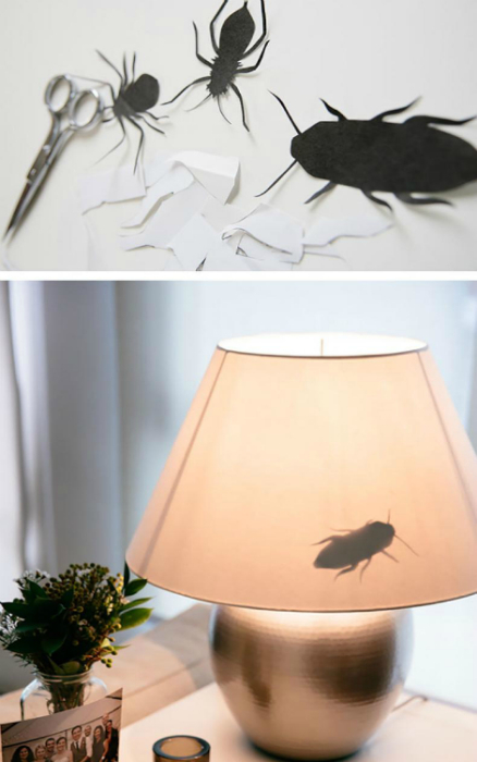 Бумажные насекомые, приклеенные к абажуру лампы.
