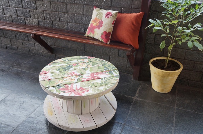 Интересный дизайн стола-катушки с прекрасным принтом с изображением цветов.
