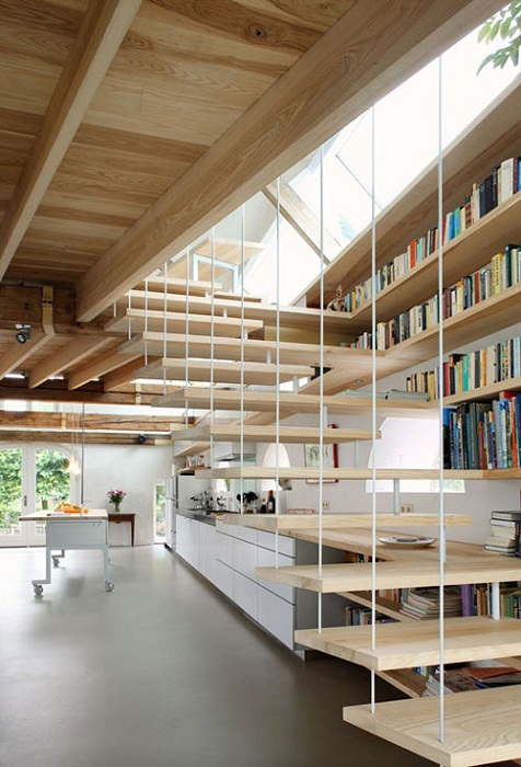 Интересная многофункциональная лестница становится частью места для хранения книг, а так же частью кухни.