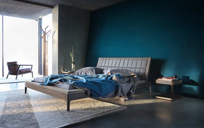 Интересное оформление комнаты в темно-синих тонах от дизайнерской компании.