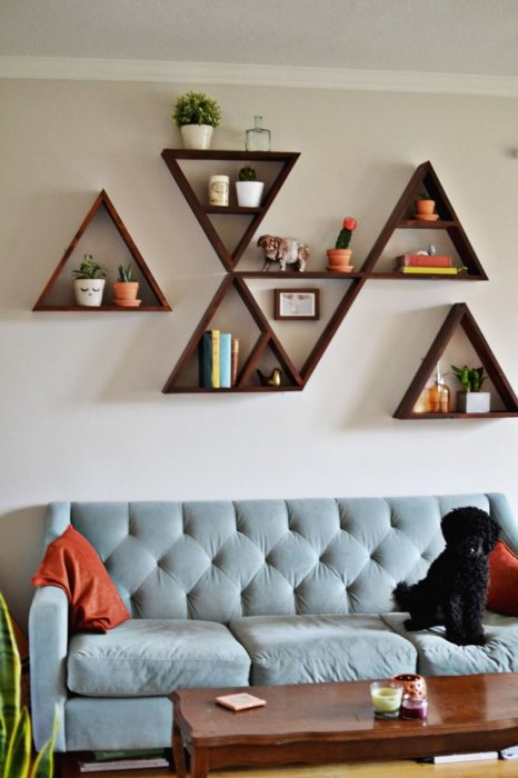 Настенные деревянные полки треугольной формы, которые легко можно заменить или переставить, позволят легко и быстро изменить интерьер в гостиной комнате.