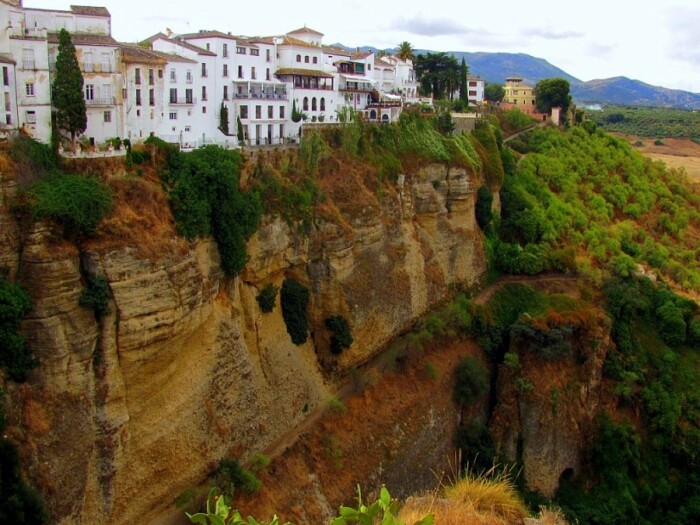 Живописная природа, окружающая «парящий» над скалой населенный пункт, гармонично дополняет городской пейзаж (Ронда, Испания). | Фото: travelvibe.net.